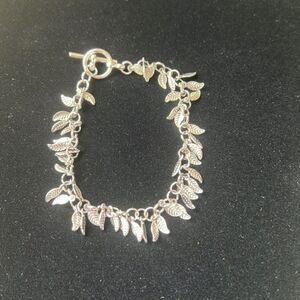 Handcrafted silver tone feather charm bracelet